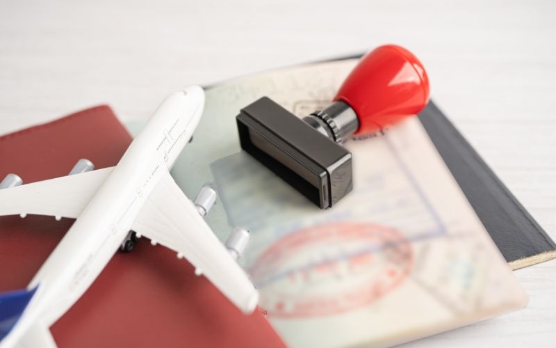 Passport and stamp on table with airoplane toy