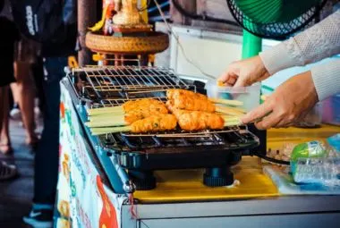 Satay skewers grilling on stall